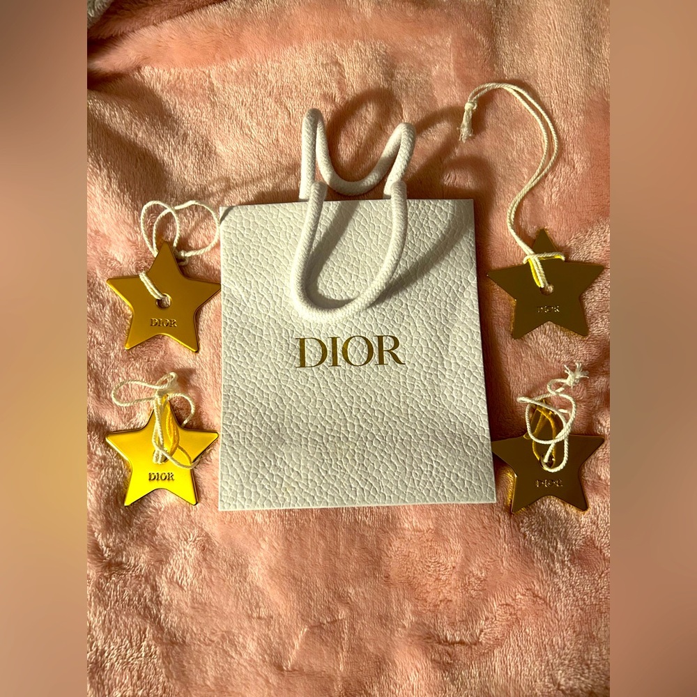 DIOR Small white paper shopping bag with four  star ornaments.